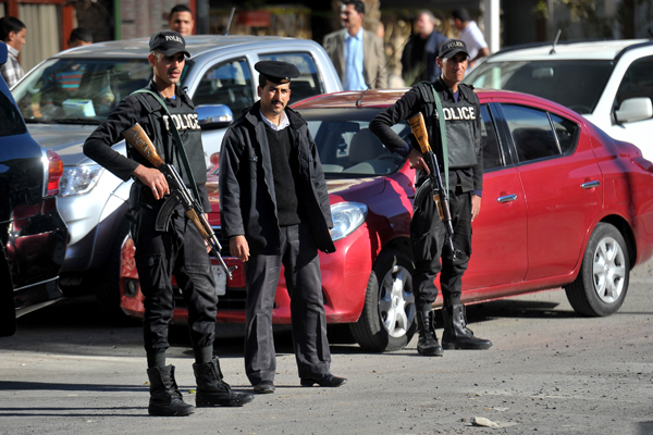 Egyptian security forces stand guard outside the four-star Bella Vista hotel, the scene of a knife attack on Friday that injured three tourists, in the Red Sea resort of Hurghada, Egypt, on Saturday (AP photo)